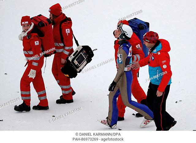 Medics accompany Austria's Florian Altenburger after his landing crash on the Bergisel ski jump at the Four Hills Tournament ski jumping world cup in Innsbruck