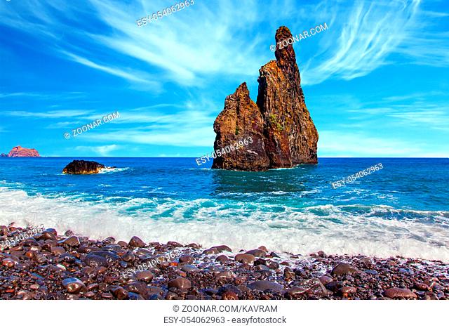 Concept of exotic and ecological tourism. Trip to the fabulous island of Madeira in the Atlantic. Two spectacular cliffs in the ocean near the pebble beach