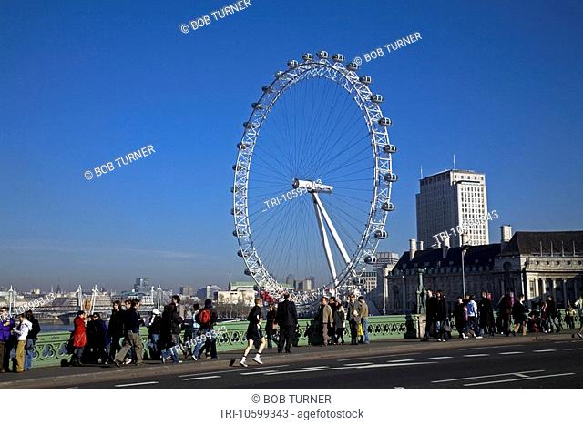 Tourists Crossing Westminster Bridge London Eye England