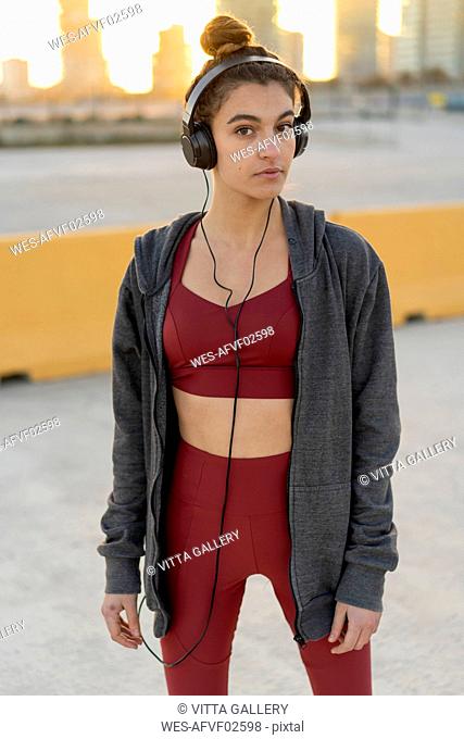 Sportive young woman with headphones during workout
