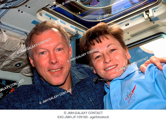 Astronauts Dominic Gorie, STS-123 commander, and Peggy Whitson, Expedition 16 commander, take a moment to pose for a photo on the aft flight deck of Space...