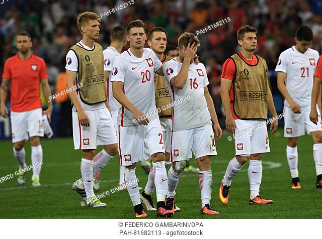 Lukasz Piszczek (2-L) and Jakub Blaszczykowski (C) of Poland react after the UEFA EURO 2016 quarter final soccer match between Poland and Portugal at the Stade...