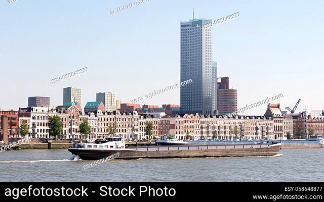 Rotterdam, Netherlands - June, 21 2018: Cityscape of Rotterdam with skycraper, houeses and a ship passing
