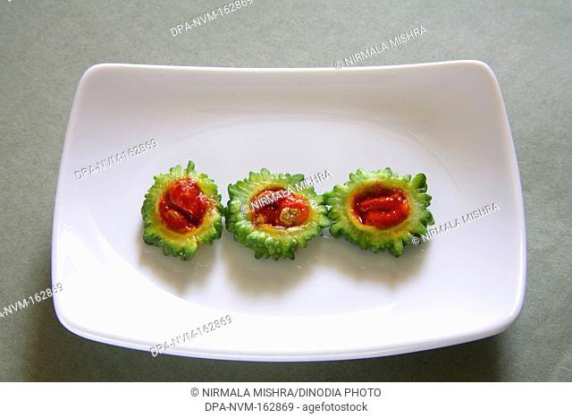 Green vegetable , slices of karela bitter gourd momordica charantia in rectangle plate on grey background