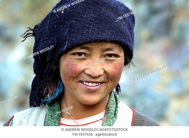Young woman at village pond Tibet