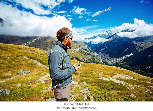 hiker at the top of a pass with backpack enjoy sunny day in Alps. Switzerland, Trek near Matterhorn mount