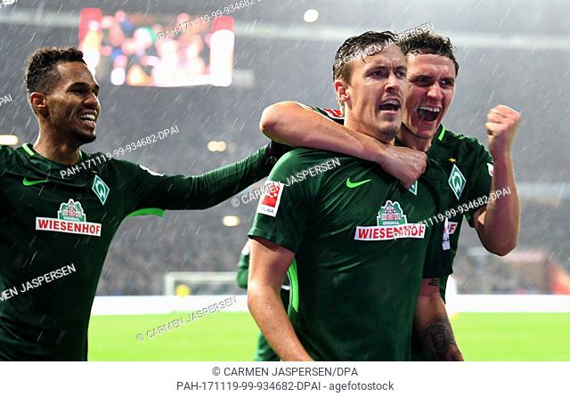 Bremen's Max Kruse (R) celebrates his 3-0 goal with team mates Theodor Gebre Selassie (L) and Milos Veljkovic during the German Bundesliga soccer match between...