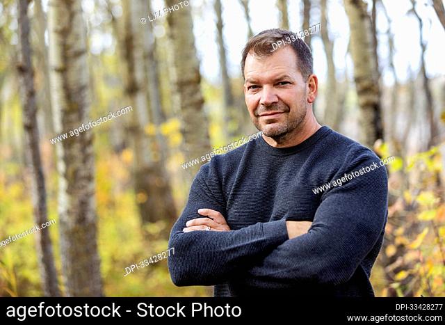 A portrait of a mature man in a city park on a warm fall afternoon; St. Albert, Alberta, Canada