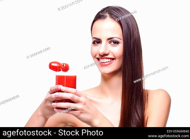 beautiful brunette young woman holding glass with tomato juice and bunch of cherry tomatoes. isolated on white background. copy space