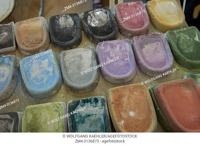 Close-up of the paint, which consists of different metallic oxides mixed in with water and determine the final colors: copper for green, iron for yellow