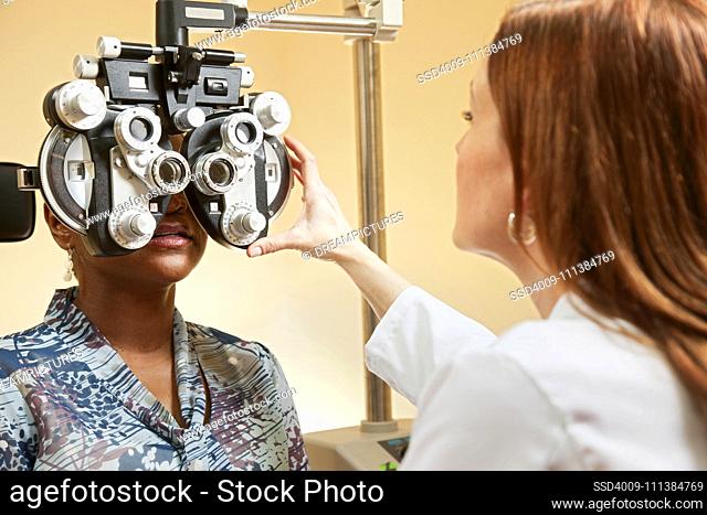 Optician adjusting equipment for patient