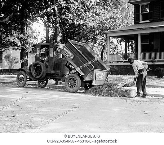 Heating Coal Being shoveled from a Ford Dump Truck, African American Worker loads a large Tub with which to convey it to the Home
