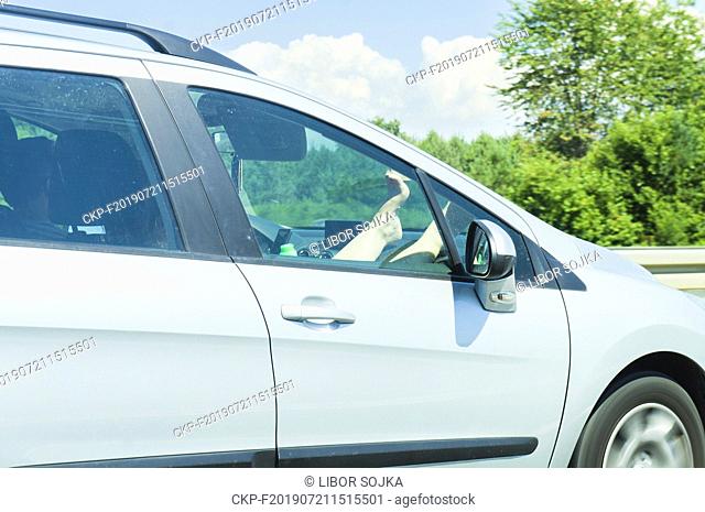 A1 motorway, female legs (leg, feet, foot) on dashboard airbag (dash, instrument panel), highway, July 6, 2019.  (CTK Photo/Libor Sojka)