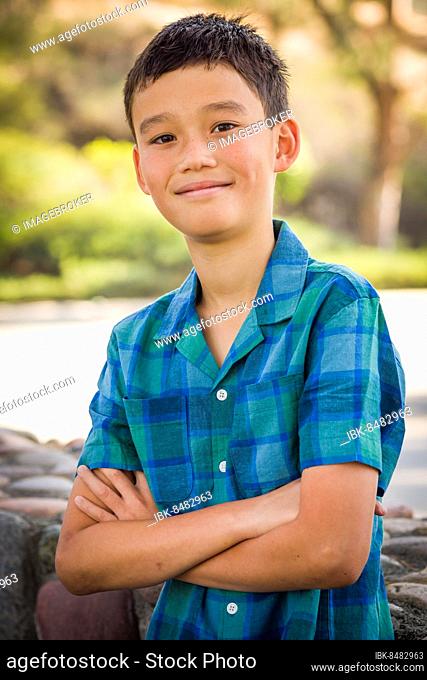 Outdoor portrait of a biracial chinese and caucasian boy