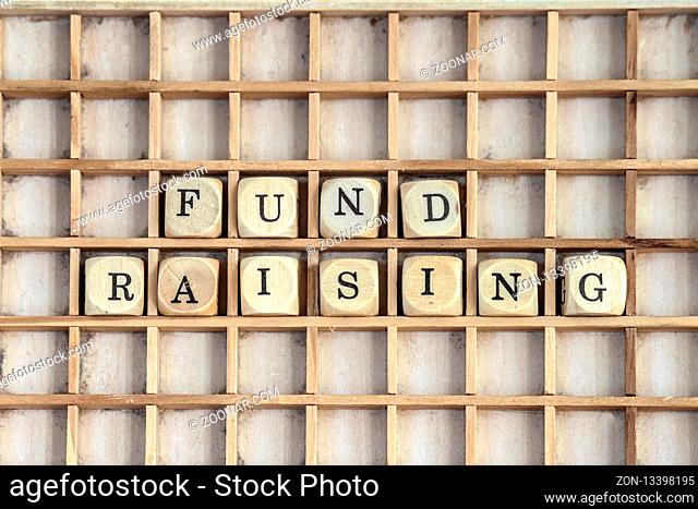 Fund raising sign made of dices on a dirty shelf made of wood