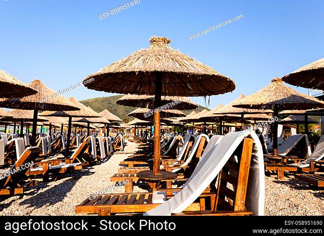 the photographed wooden umbrellas located in the territory of a beach