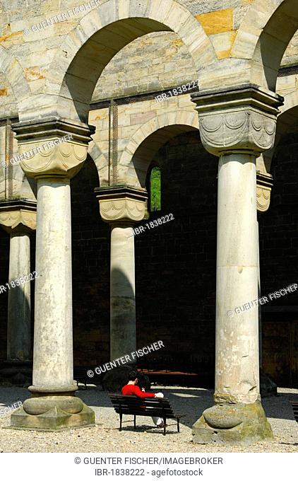Visitors on the porch with round Romanesque columns, ruins of the Paulinzella Benedictine Monastery, Rottenbachtal, Thuringia, Germany, Europe