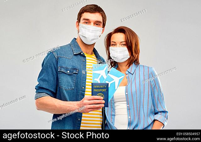 couple in masks with tickets and immunity passport