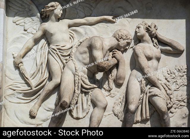 Sculptural relief of Adam and Eve being banished from Garden of Eden on exterior of Milan Cathedral (Duomo di Milano), Piazza del Duomo, Milan, Lombardy, Italy