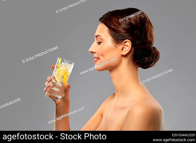 woman drinking water with lemon and ice