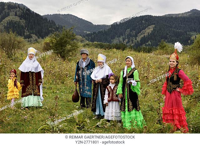 Kazakh family in traditional clothes after Tusau Kesu ceremony in field at Huns Village Kazakhstan