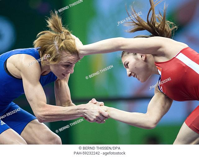 Julie Sabatie (red) of France and Iwona Matkowska (blue) of Poland compete in the women's Freestyle 48kg wrestling Bronze Medal Final at the Baku 2015 European...