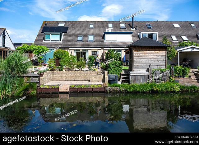 Barendrecht, South Holland, The Netherlands, July 4, 2023 - House with backyard in a small creek