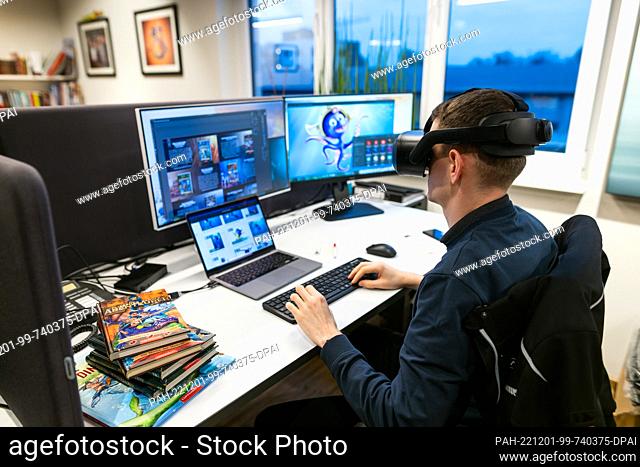 ILLUSTRATION - 30 November 2022, Baden-Wuerttemberg, Rust: An employee of ""Macknext"" sits at a workstation prepared for the photo during a press event