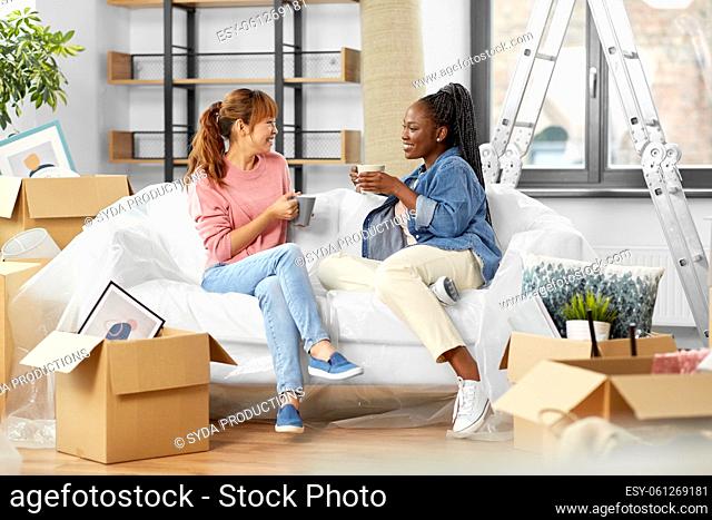 women moving to new home and drinking coffee