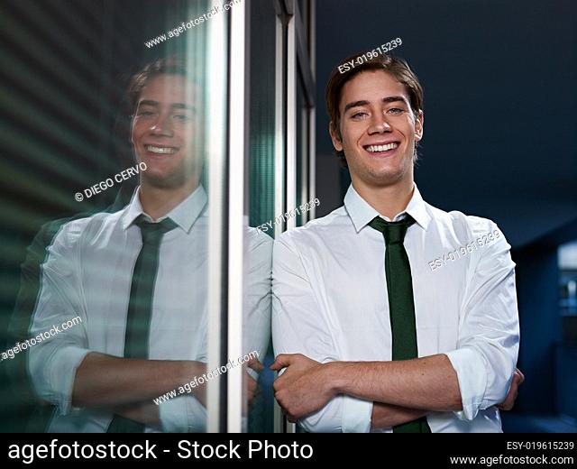 businessman with arms crossed smiling at camera
