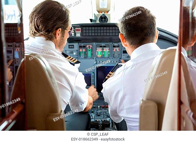 Pilot And Copilot In Private Jet Cockpit