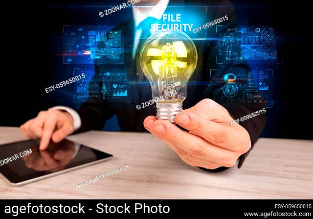 Businessman holding lightbulb with FILE SECURITY inscription, online security idea concept