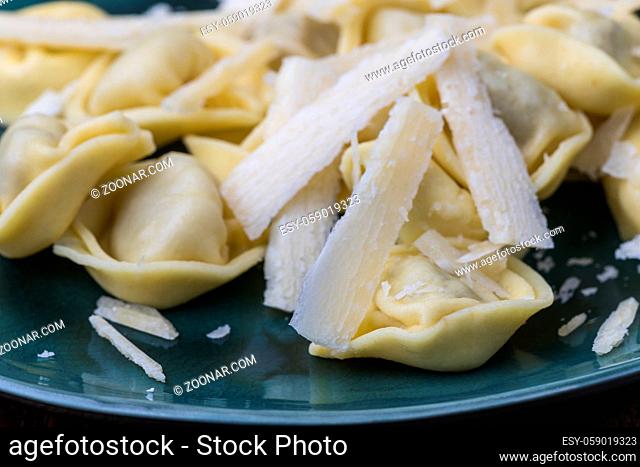 tortellini pasta with parmesan cheese on a plate
