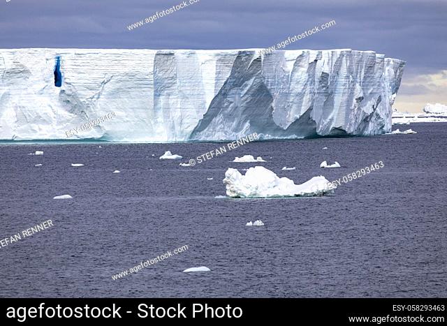 Huge iceberg drifts through calm sea in Antarctica