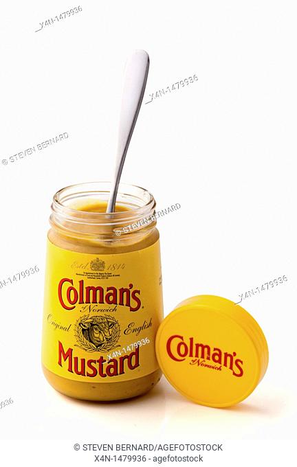 Colman's English mustard jar and spoon against a white background