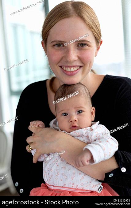 Portrait of a new mother with her baby daughter; Surrey, British Columbia, Canada