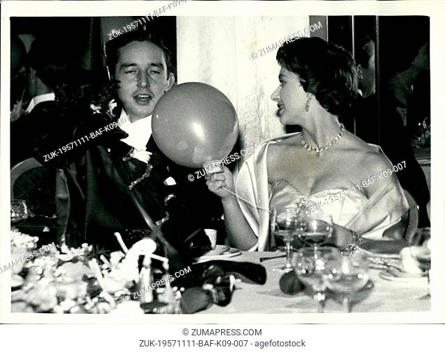 Nov. 11, 1957 - Princess Margaret attends Hallowe'en Ball: Photo shows Princess Margaret and her escort Mr. Billy Wallace - with a baloon and a toy 'Witch' at...