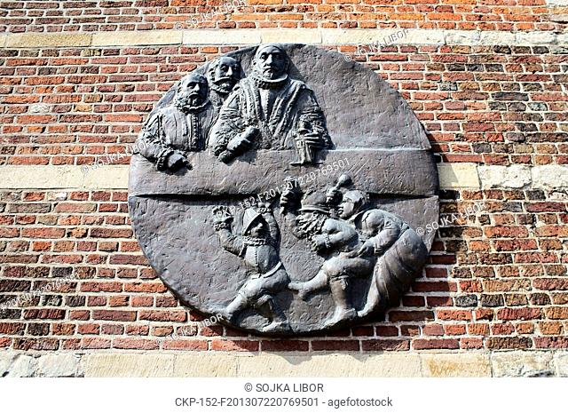 Relief bronze sculpture on the wall of the old Academy building of University of Leiden by sculptor Theo van de Vathorst