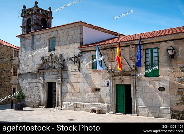 MELIDE, SPAIN - AUGUST 30, 2018: Panoramic image of the town hall in the city center of Melide with blue sky on August 30, 2018 in Galicia, Spain