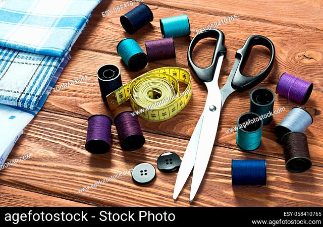 Bright image of sewing kit accessories on wooden table