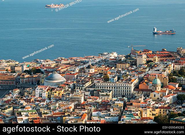 Naples, Italy. Top View Cityscape Skyline With Famous Landmarks And Part Of Gulf Of Naples With Ships In Sunny Day. Many Old Churches And Temples