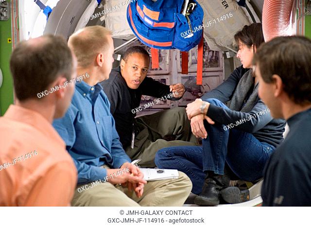 NASA astronauts Tim Kopra (second left), Alvin Drew and Nicole Stott, all STS-133 mission specialists, participate in a training session in an International...