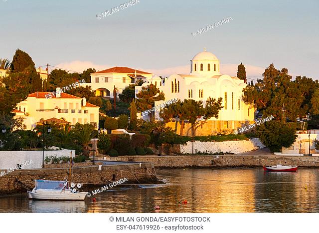 Houses and a church in the harbor of Spetses village, Greece.