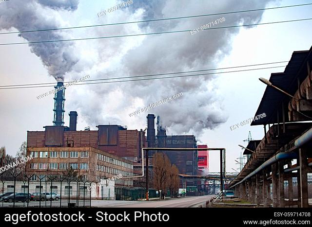 huge metallurgical plant pollutes the atmosphere with harmful smoke from pipes