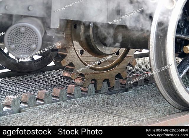 12 May 2021, Switzerland, Goldau: The cogwheel of the 148-year-old steam locomotive 7 engages the rack on the route up the Rigi mountain massif