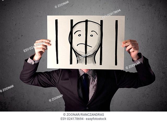 Businessman holding a paper with a prisoner behind the bars on it in front of his head