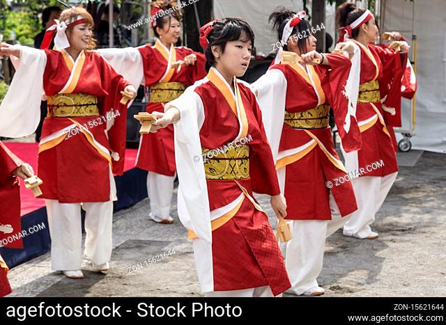Tokyo, Japan - September 24 2017: Dancers in traditional red and white clothing perfoming japananese Dance at Shinagawa Shukuba Matsuri festival