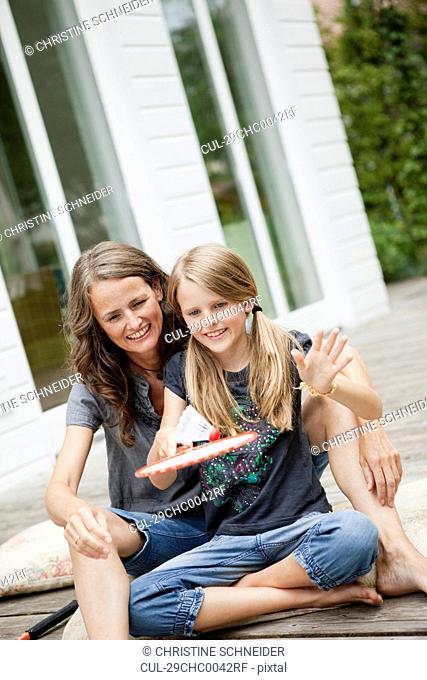 Mother and daughter playing badminton