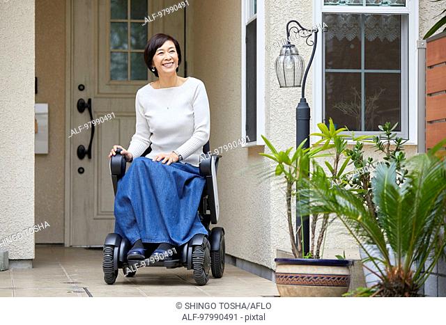Japanese senior woman on electric wheelchair