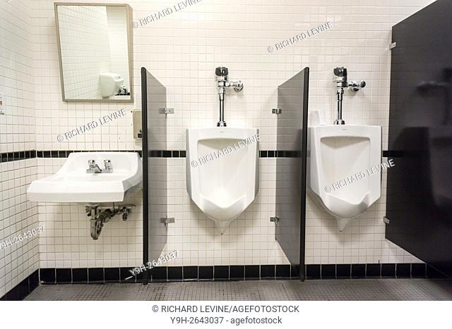 Urinals await customers in a restroom in New York